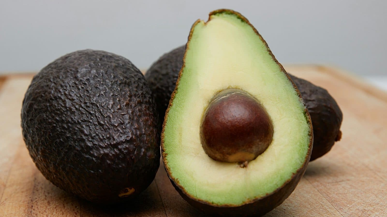 sliced avocado fruit on brown wooden table