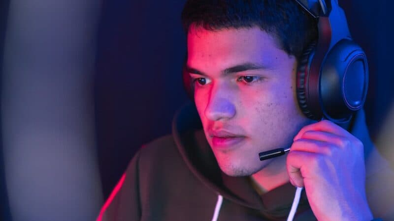 man in red hoodie wearing black headphones